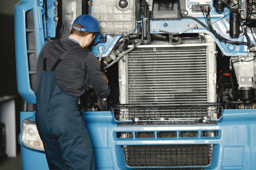 Semi truck driver repairing a heavy truck in Calgary