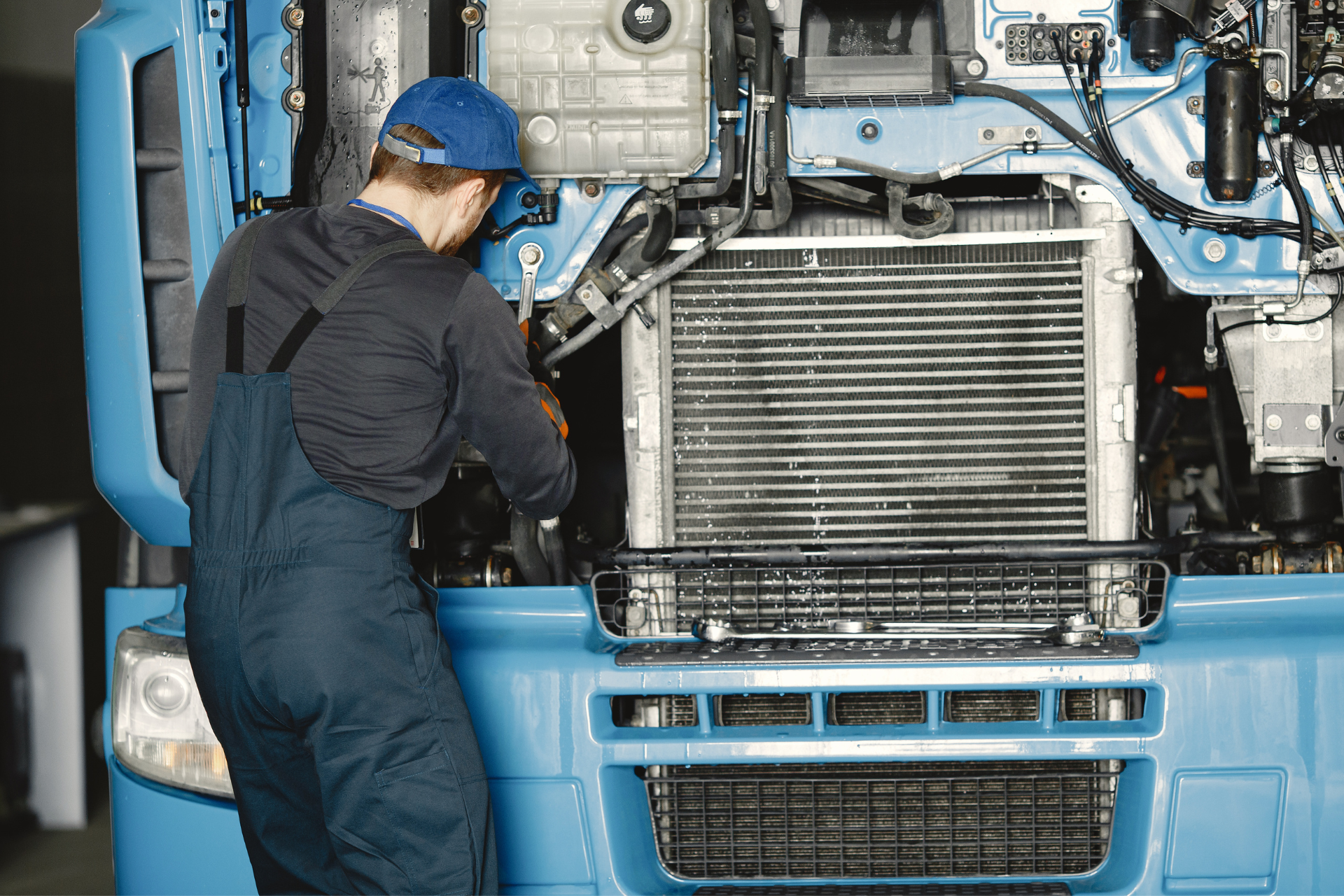 Semi truck driver repairing a heavy truck in Calgary