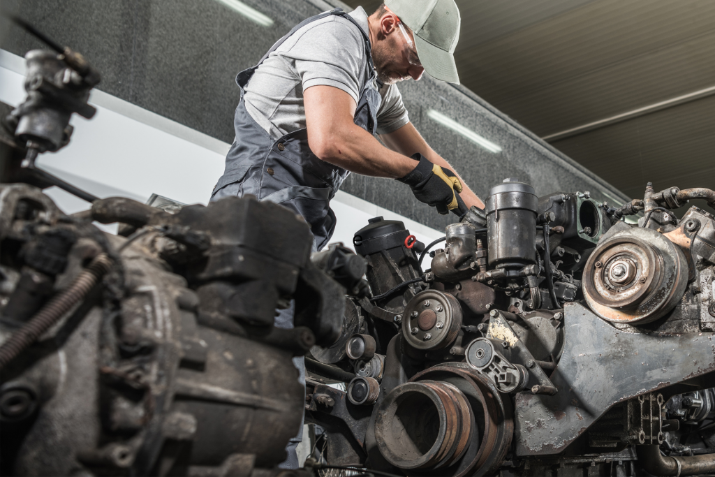 Heavy truck mechanic repairing a semi truck engine