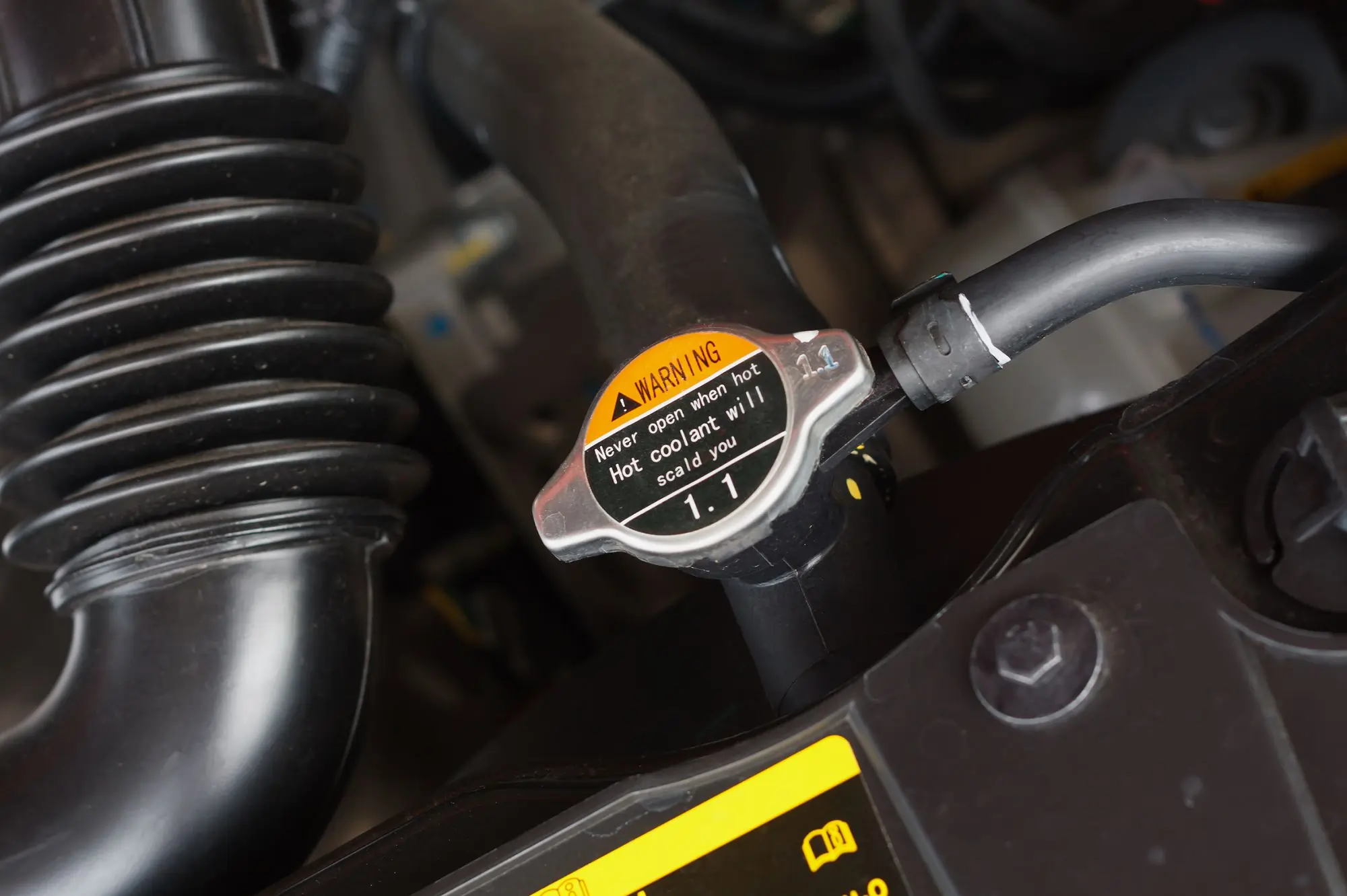 Mechanic inspecting a truck radiator for coolant leaks