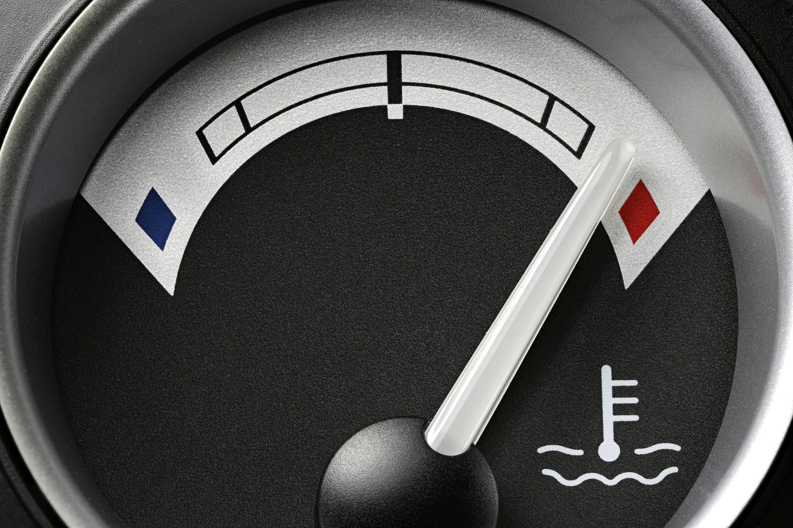 Mechanic inspecting a truck engine after overheating caused head gasket and piston damage